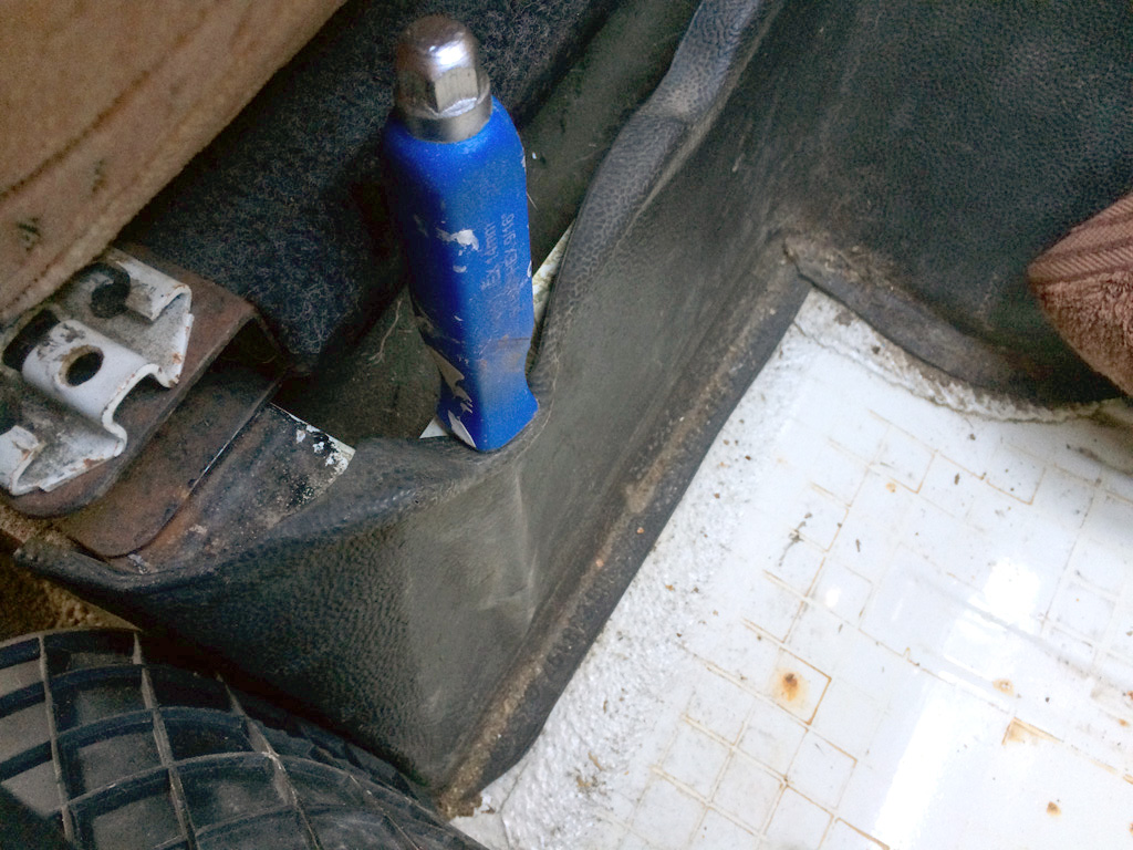 Flathead screwdriver used to prise channel in trunking for cable