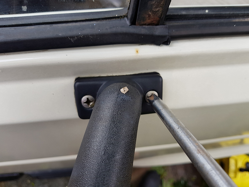 Unbolting the mirror from the door