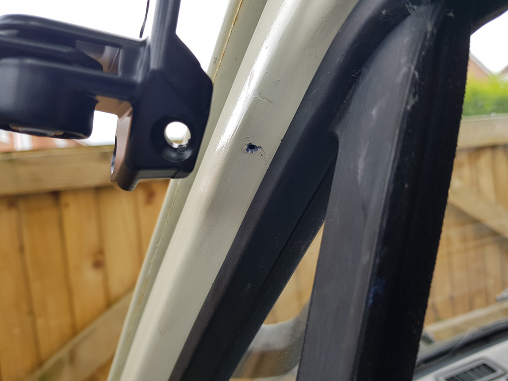 Guide hole drilled for longer upper bracket screw